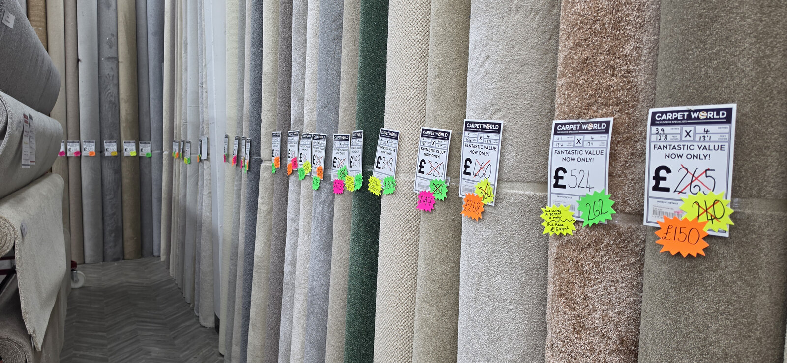 End-of-roll carpet remnants on the rack at Carpet World London in Chingford, with reduced prices